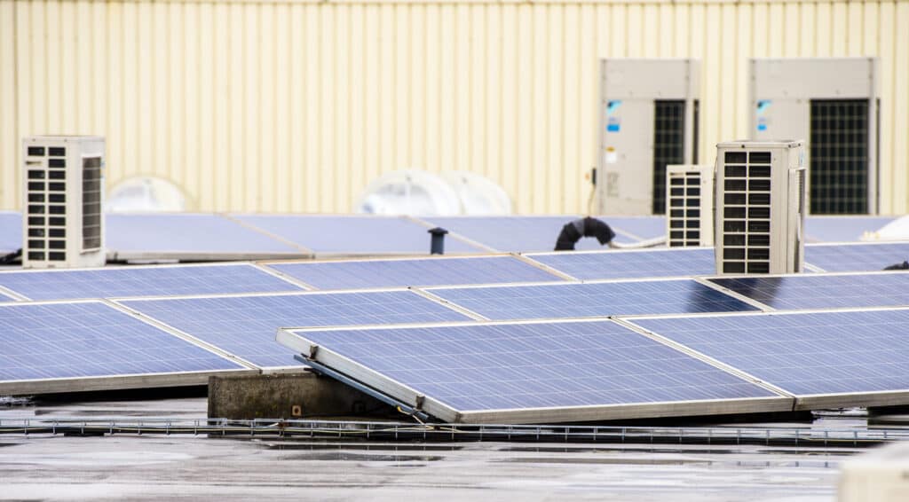 Renewable energy - solar panels on factory rooftop